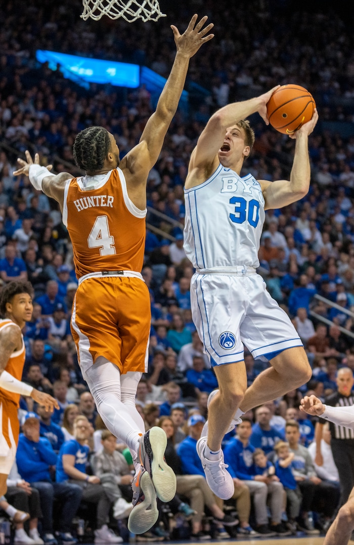 (Rick Egan | The Salt Lake Tribune) Brigham Young Cougars guard Dallin Hall (30) shoots as Texas Longhorns guard Tyrese Hunter (4) defends, in basketball action between the Brigham Young Cougars and the Texas Longhorns, at the Marriott Center, on Saturday, Jan. 27, 2024.
