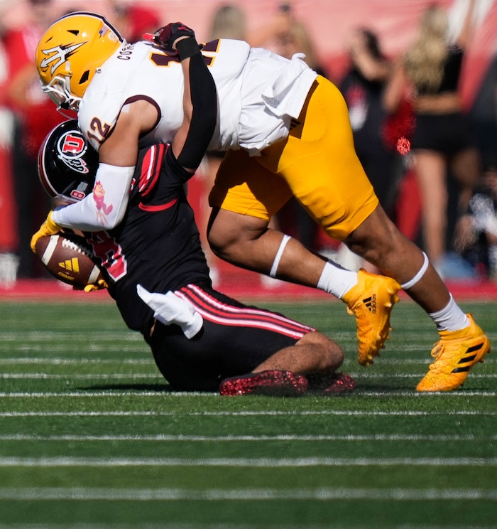 (Francisco Kjolseth  |  The Salt Lake Tribune) Utah Utes safety Cole Bishop (8) gets sandwiched between the ball and Arizona State Sun Devils tight end Jalin Conyers (12) in NCAA football in Salt Lake City on Saturday, Nov. 4, 2023.