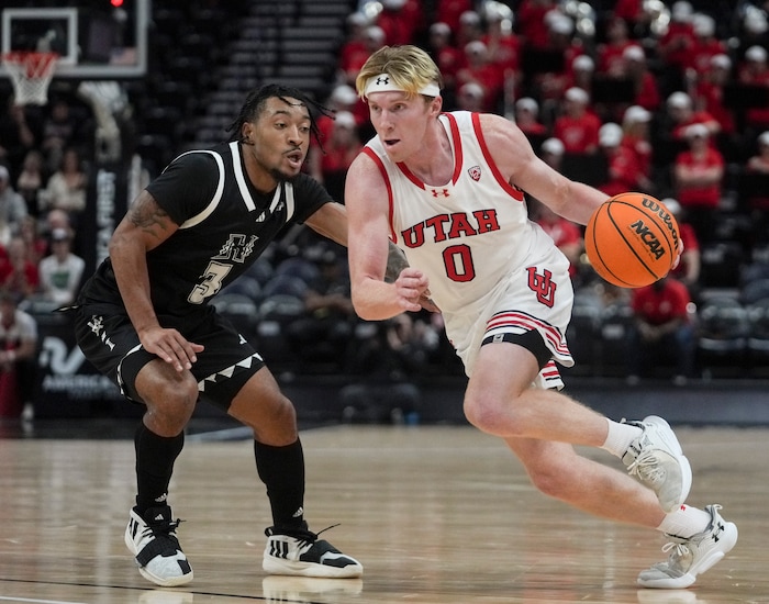 (Bethany Baker  |  The Salt Lake Tribune) Utah Utes guard Hunter Erickson (0) goes to the basket as Hawaii Warriors guard JoVon McClanahan (3) defends at the Delta Center in Salt Lake City on Thursday, Nov. 30, 2023.