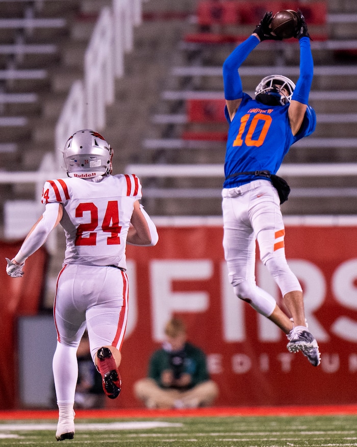 (Rick Egan | The Salt Lake Tribune)   Timpview Thunderbird wide receiver Tei Nacua grabs a pass, as Joshua Liljenquist defends for Bountiful, in 5A State playoff action between the Timpview Thunderbirds and the Bountiful Redhawks, at Rice-Eccles Stadium, on Friday, Nov. 17, 2023.
