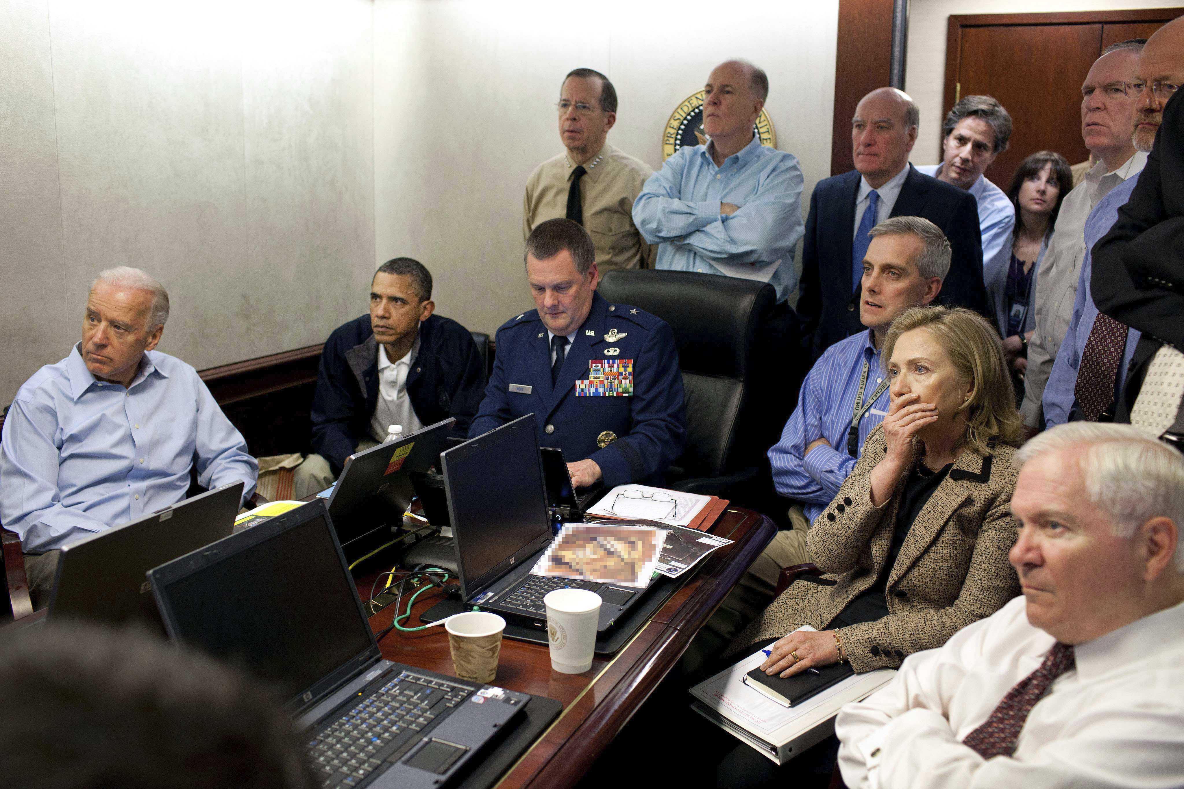  (Pete Souza | The White House via AP) In this image released by the White House and digitally altered by the source to diffuse the paper in front of Secretary of State Hillary Rodham Clinton, President Barack Obama and Vice President Joe Biden, along with with members of the national security team, receive an update on the mission against Osama bin Laden in the Situation Room of the White House on Sunday, May 1, 2011, in Washington.
