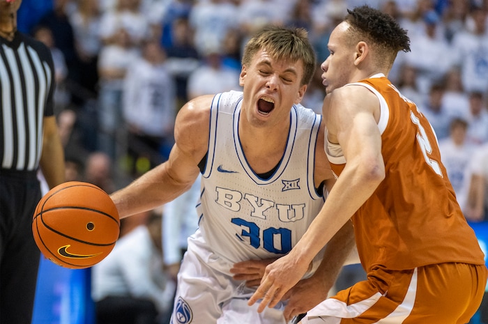 (Rick Egan | The Salt Lake Tribune) Brigham Young Cougars guard Dallin Hall (30) collides with Texas Longhorns guard Chendall Weaver (2), in basketball action at the Marriott Center, on Saturday, Jan. 27, 2024.
