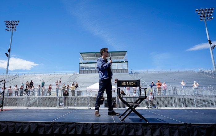 (Bethany Baker  |  The Salt Lake Tribune) Kevin Bacon speaks on stage during a charity event to commemorate the 40th anniversary of the movie "Footloose" on the football field of Payson High School in Payson on Saturday, April 20, 2024.