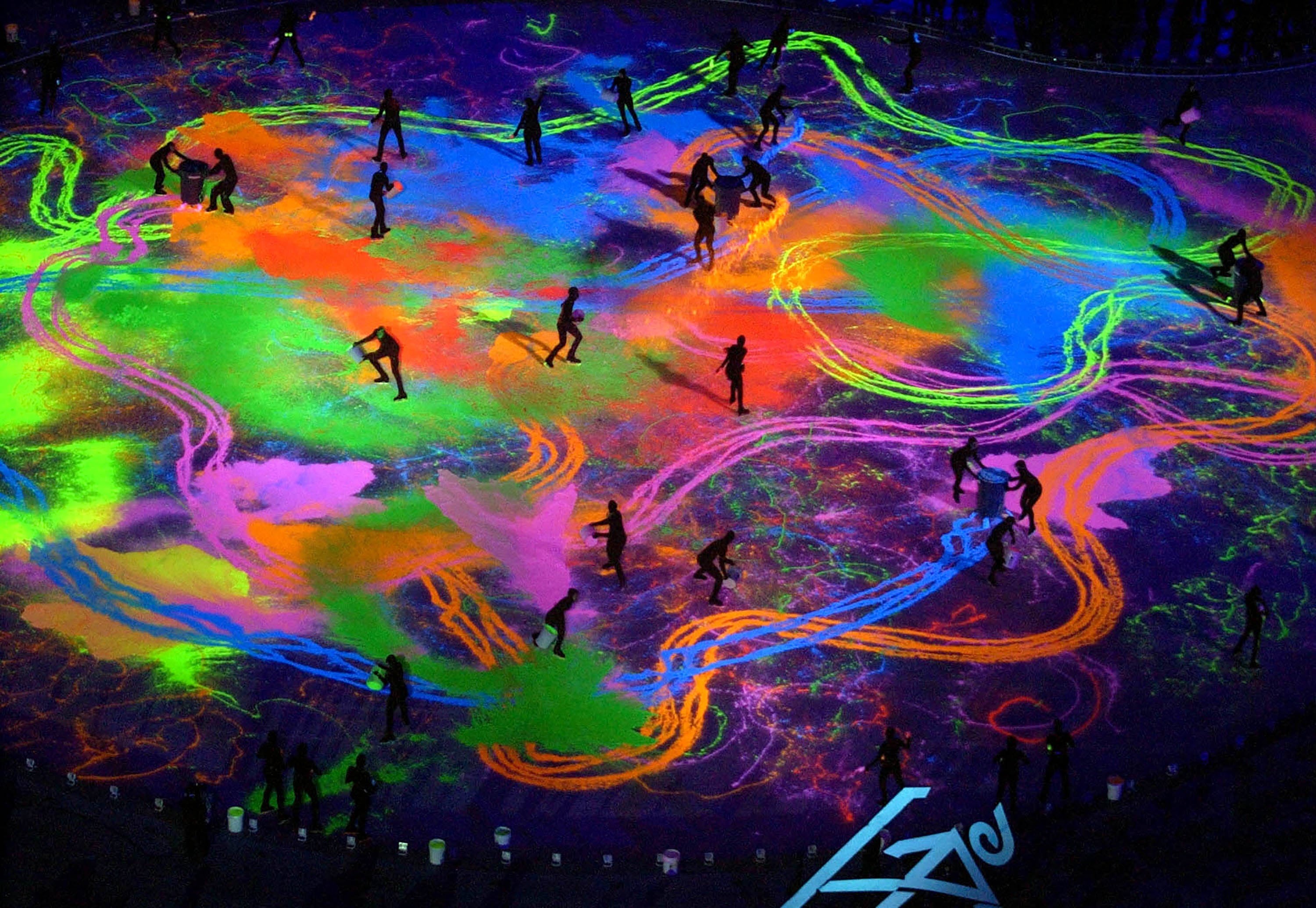 (Paul Fraughton | The Salt Lake Tribune) The stage ice is covered with colored sand under black light during the closing ceremony of the 2002 Winter Olympics at Rice-Eccles Stadium in Salt Lake City, Sunday, Feb. 24, 2002.