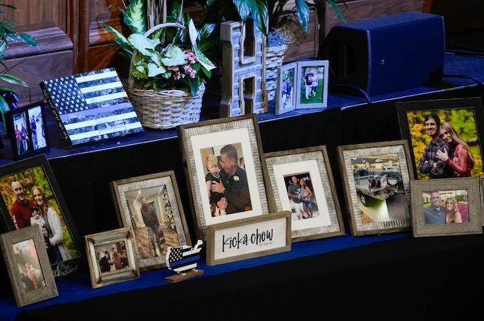 (Francisco Kjolseth  |  The Salt Lake Tribune) Family photographs during funeral services for Santaquin police Sgt. Bill Hooser at the UCCU Center at Utah Valley University on Monday, May 13, 2024.