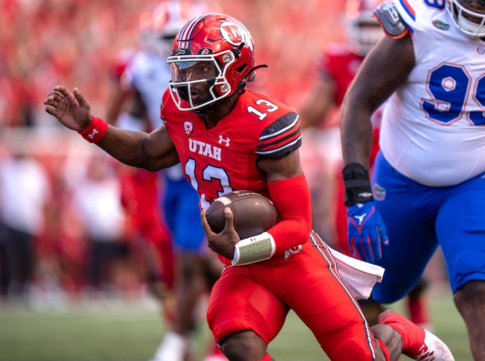 (Rick Egan | The Salt Lake Tribune) Utah Utes quarterback Nate Johnson (13) runs for a touchdown in football action between the Utah Utes and the Florida Gators at Rice-Eccles Stadium on Thursday, Aug. 31, 2023.