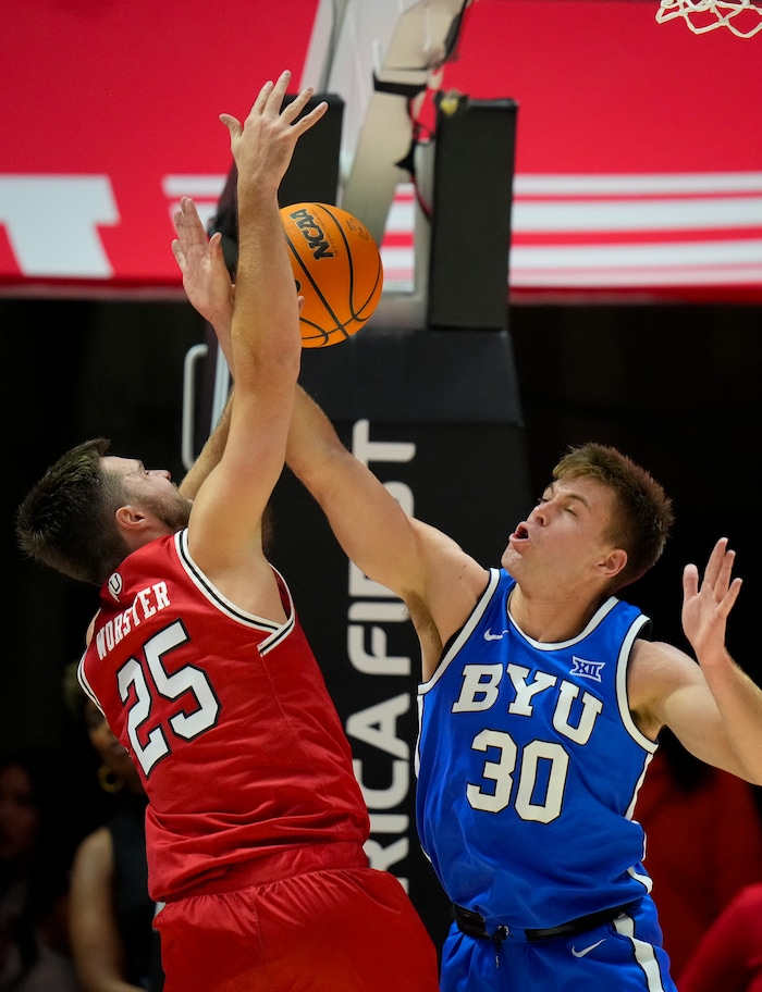 (Bethany Baker  |  The Salt Lake Tribune) Utah Utes guard Rollie Worster (25) shoots as Brigham Young Cougars guard Dallin Hall (30) blocks at the Jon M. Huntsman Center in Salt Lake City on Saturday, Dec. 9, 2023.