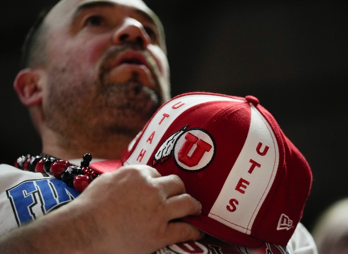 (Bethany Baker  |  The Salt Lake Tribune) A Utah Utes fan stands during the National Anthem at the Jon M. Huntsman Center in Salt Lake City on Saturday, Dec. 9, 2023.