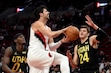 (Steve Dykes | AP) Portland Trail Blazers forward Deni Avdija, center, drives to the basket against Utah Jazz forward Taylor Hendricks (0) and center Walker Kessler (24) during the first half of a preseason NBA basketball game in Portland, Ore., Friday, Oct. 18, 2024.