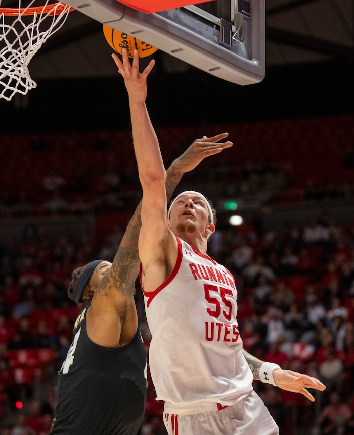 (Rick Egan | The Salt Lake Tribune) Utah Utes guard Gabe Madsen (55) shoots as Colorado Buffaloes center Eddie Lampkin Jr. (44) defends, in PAC-12 basketball action between the Utah Utes and the Colorado Buffaloes a the Jon M. Huntsman Center, on Saturday, Feb. 3, 2024.
