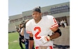 (Joseph R. Villarin | AP) Deion Sanders walks out of the San Francisco 49ers' practice facility on Sept. 15, 1994. The free-agent defensive back signed a one-year $1.1 million contract with the 49ers, where he first met future BYU athletics director Tom Holmoe.