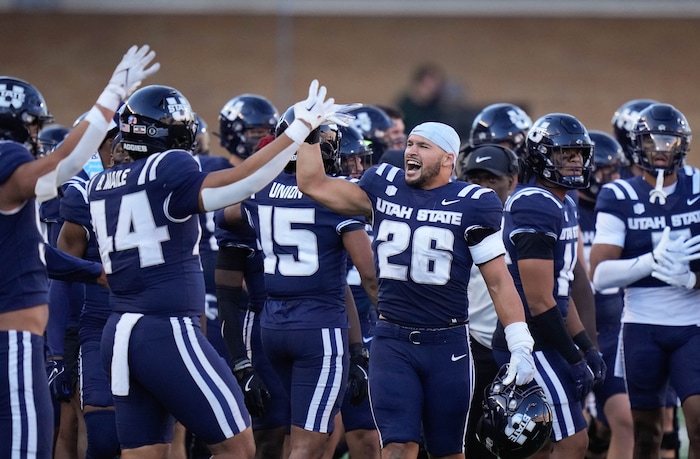 (Francisco Kjolseth  | The Salt Lake Tribune) Aggies players celebrate some gains on Utah as Utah State hosts the University of Utah during the second half of an NCAA college football game Saturday, Sept. 14, 2024, in Logan, Utah.