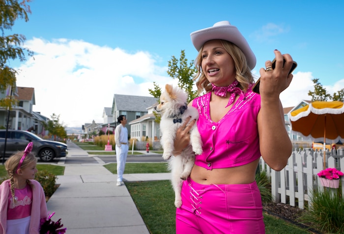 (Bethany Baker  |  The Salt Lake Tribune) Jamie Tucker, dressed as “Classic Barbie” from the movie “Barbie,” talks about how she and her neighbors came together to collectively create a Barbieland-themed community for Halloween in Daybreak on Wednesday, Oct. 11, 2023.