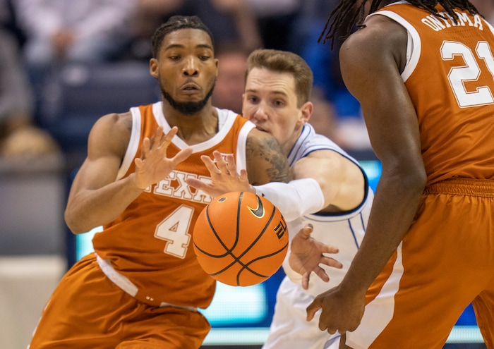 (Rick Egan | The Salt Lake Tribune) Brigham Young guard Spencer Johnson (20) squeezes past a screen set by Texas Longhorns forward Ze'Rik Onyema (21) as he goes for the ball along with Texas Longhorns guard Tyrese Hunter (4), in basketball action between the Brigham Young Cougars and the Texas Longhorns, at the Marriott Center, on Saturday, Jan. 27, 2024.
