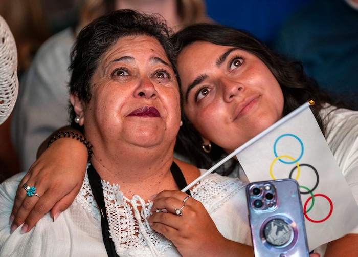 (Rick Egan | The Salt Lake Tribune) Elisa Huhem, right, hugs her mother,
Patricia, as they watch a live stream at Salt Lake City Hall of the vote to host the 2034 Winter Olympics, on Wednesday, July 24, 2024.