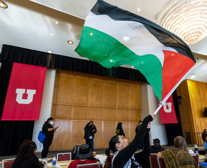 (Rick Egan | The Salt Lake Tribune)  Palestinian student Muna Omar waves a flag during a sit-in, as the group Mecha occupies the Union Ballroom during a protest on the University of Utah Campus, on Wednesday, Nov. 15, 2023.
