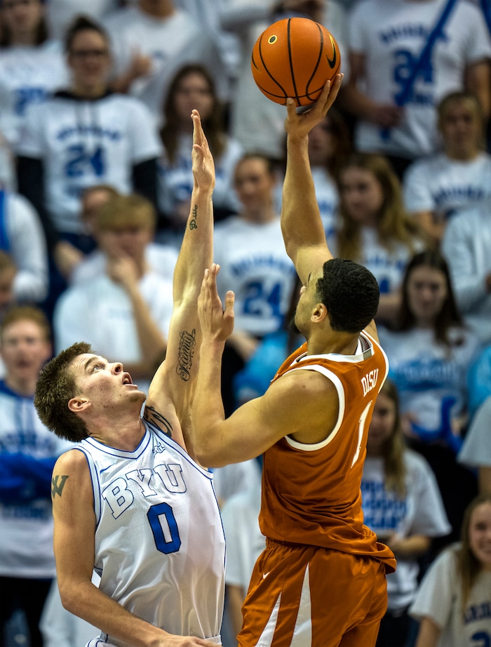 (Rick Egan | The Salt Lake Tribune) Texas Longhorns forward Dylan Disu (1) shoots as Brigham Young Cougars forward Noah Waterman (0) defends, in basketball action at the Marriott Center, on Saturday, Jan. 27, 2024.
