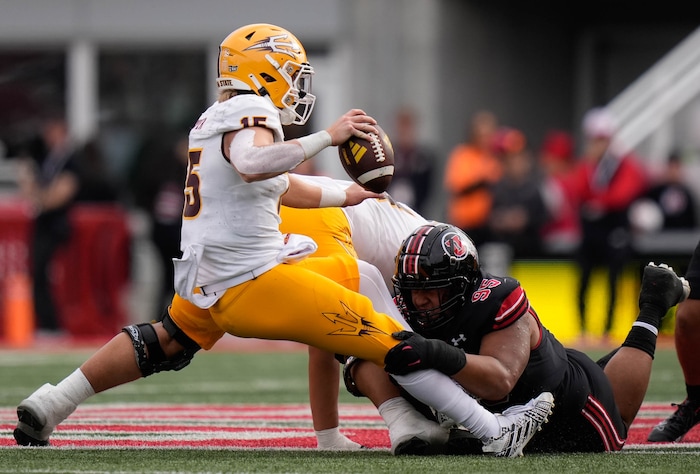 (Francisco Kjolseth  |  The Salt Lake Tribune) Arizona State Sun Devils quarterback Jacob Conover (15) falls back as he’s taken down by Utah Utes defensive tackle Aliki Vimahi (95) as the Utah Utes host the Arizona State Sun Devils in NCAA football in Salt Lake City on Saturday, Nov. 4, 2023.