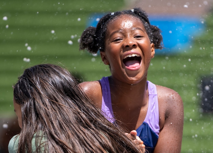 (Rick Egan | The Salt Lake Tribune)  Penny Rodriguez and London Larkin play in the fountain at The Gateway mall during a Juneteenth celebration on Monday, June 19, 2023.