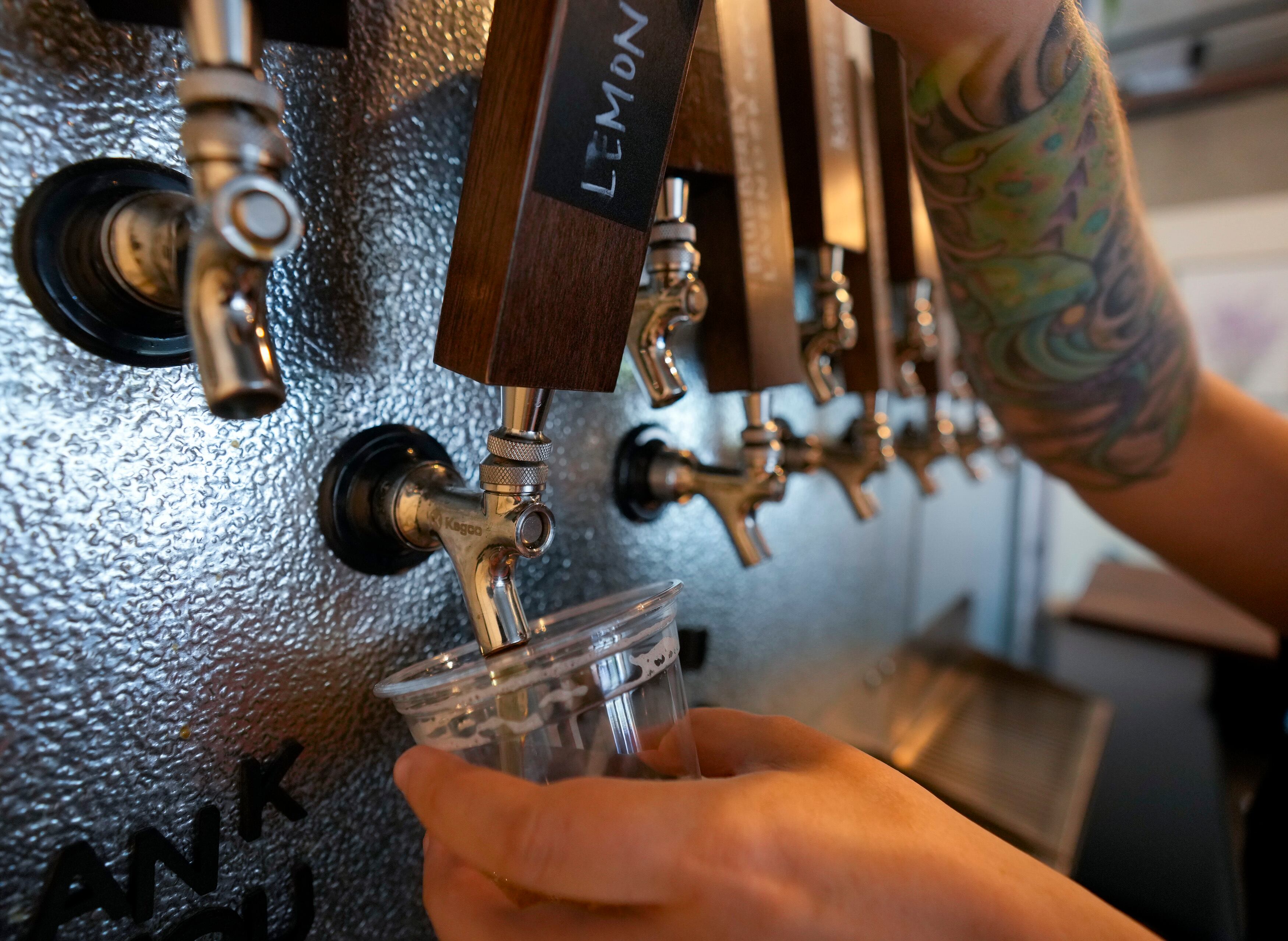 (Bethany Baker | The Salt Lake Tribune) A patron pours their own glass of kombucha at Renourish Taproom, a kombucha taproom that recently adopted a "staffless" business model, in Salt Lake City on Wednesday, June 12, 2024.