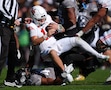 Utah quarterback Isaac Wilson, top, is tackled after a short gain by Colorado linebacker Nikhai Hill-Green in the first half of an NCAA college football game Saturday, Nov. 16, 2024, in Boulder, Colo. (AP Photo/David Zalubowski)