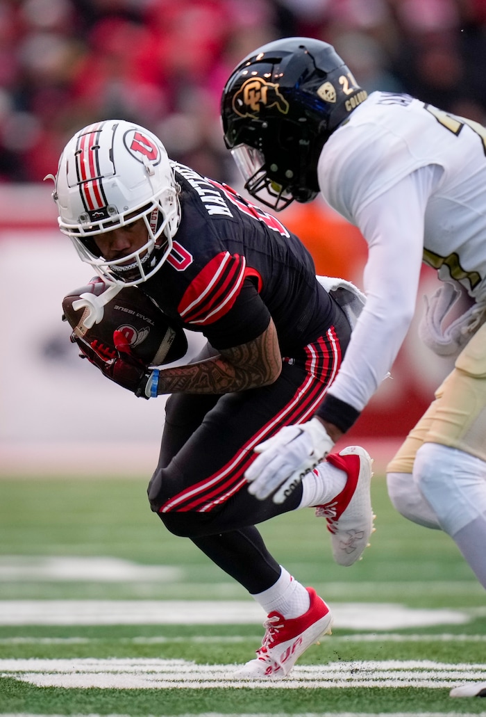 (Bethany Baker  |  The Salt Lake Tribune) Utah Utes wide receiver Mikey Matthews (0) runs the ball as Colorado Buffaloes safety Shilo Sanders (21) defends at Rice-Eccles Stadium in Salt Lake City on Saturday, Nov. 25, 2023.