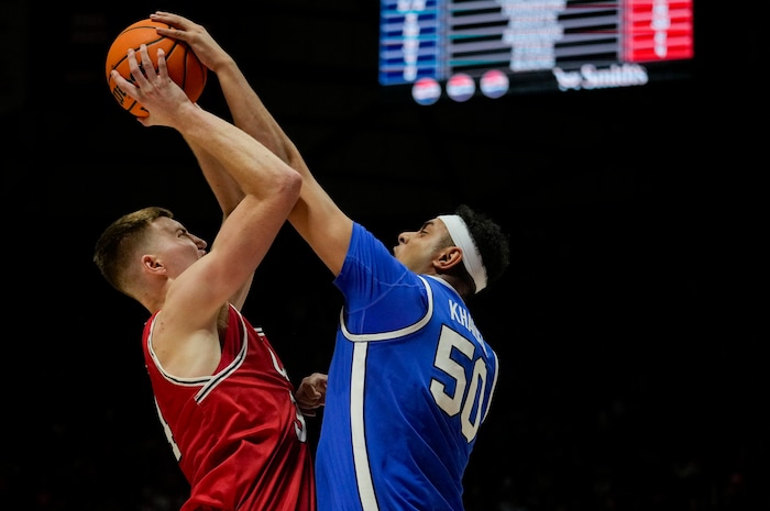 (Bethany Baker  |  The Salt Lake Tribune) Brigham Young Cougars center Aly Khalifa (50) blocks a shot by Utah Utes center Lawson Lovering (34) at the Jon M. Huntsman Center in Salt Lake City on Saturday, Dec. 9, 2023.