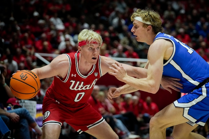 (Bethany Baker  |  The Salt Lake Tribune) Utah Utes guard Hunter Erickson (0) dribbles around Brigham Young Cougars guard Richie Saunders (15) at the Jon M. Huntsman Center in Salt Lake City on Saturday, Dec. 9, 2023.