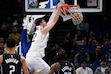 Utah Jazz forward Kyle Filipowski (22) dunks as Orlando Magic guard Caleb Houstan (2) and center Wendell Carter Jr., front right, look on during the second half of an NBA basketball game, Sunday, Jan. 5, 2025, in Orlando, Fla. (AP Photo/Phelan M. Ebenhack)