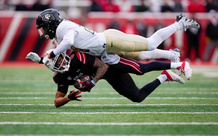 (Bethany Baker  |  The Salt Lake Tribune) Utah Utes wide receiver Mikey Matthews (0) is tackled by Colorado Buffaloes safety Shilo Sanders (21) at Rice-Eccles Stadium in Salt Lake City on Saturday, Nov. 25, 2023.