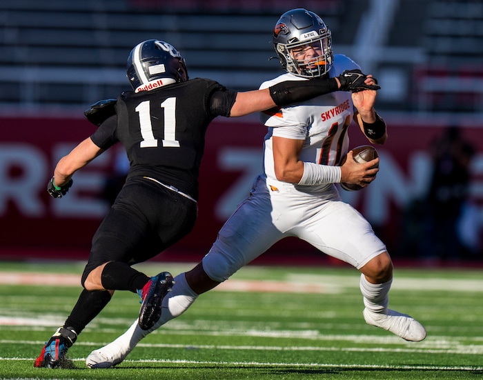 (Rick Egan | The Salt Lake Tribune)  Corner Canyon Defensive End Sam Chandler puts pressure on Skyridge QB Jackson Stevens, in 6A State playoff action between the Corner Canyon Chargers and the Skyridge Falcons, at Rice-Eccles Stadium, on Friday, Nov. 17, 2023.