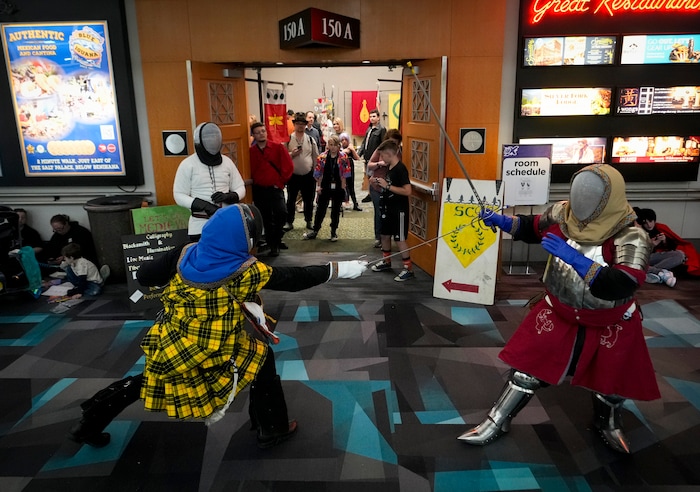 (Bethany Baker | Salt Lake Tribune) Two fencers from Society of Creative Anachronism fight in front of a crowd during FanX at Salt Palace Convention Center in Salt Lake City on Friday, Sept. 22, 2023.