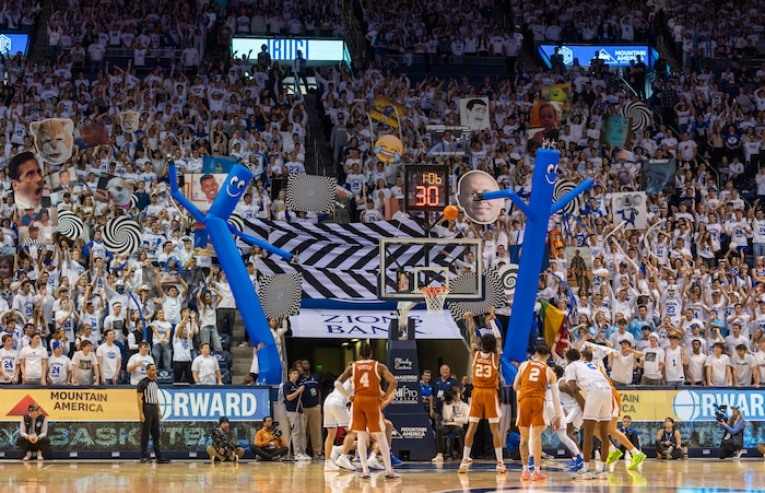 (Rick Egan | The Salt Lake Tribune) Brigham Young Cougars fans tru to distract Texas Longhorns forward Dillon Mitchell (23) as he shoots a free throw, in basketball action between the Brigham Young Cougars and the Texas Longhorns, at the Marriott Center, on Saturday, Jan. 27, 2024.
