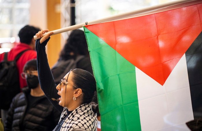 (Rick Egan | The Salt Lake Tribune)  Muna Omar waves a flag a supporters of Mecha protest on the University of Utah Campus, on Wednesday, Nov. 15, 2023.
