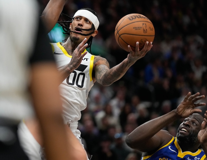 (Francisco Kjolseth  |  The Salt Lake Tribune) Utah Jazz guard Jordan Clarkson (00) pushes past Golden State Warriors forward Draymond Green (23) during an NBA basketball game Thursday, Feb. 15, 2024, in Salt Lake City.