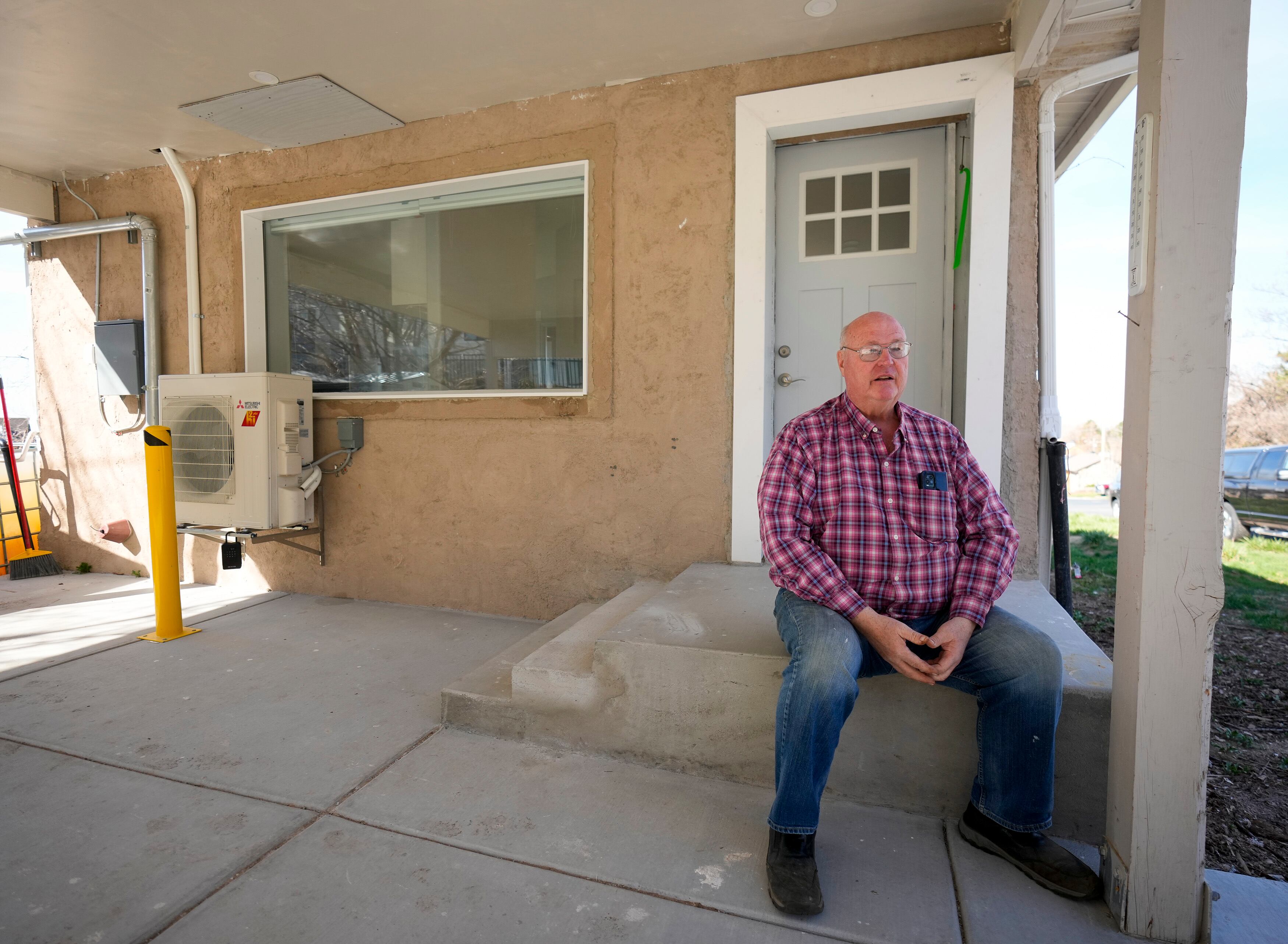 (Bethany Baker | The Salt Lake Tribune) Wayne Kartchner sits on the porch of his recently renovated accessory dwelling unit, or ADU, beside his home in Farmington on Friday, March 22, 2024.