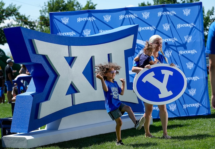 (Francisco Kjolseth | The Salt Lake Tribune) Jolene Romero and her kids Sam, 2, and Dean, 6, become animated for a fast moving video camera as BYU celebrates their entrance into the Big 12 Conference with a big party on campus on Saturday, July 1, 2023.