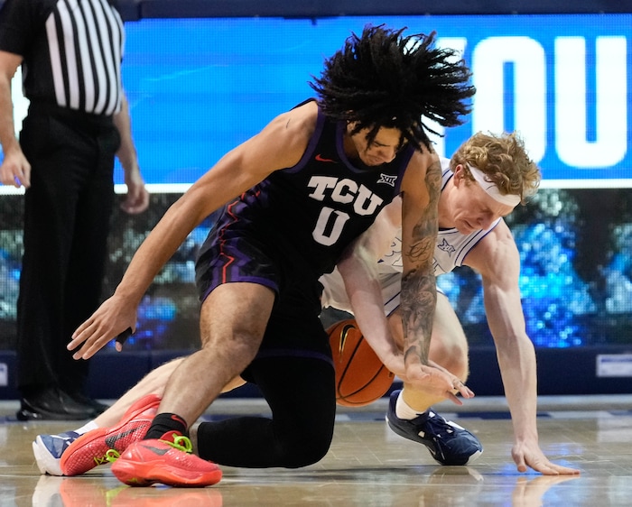 (Francisco Kjolseth  |  The Salt Lake Tribune) TCU Horned Frogs guard Micah Peavy (0) battles Brigham Young Cougars guard Richie Saunders (15) for a loose ball during an NCAA college basketball game against TCU Saturday, March 2, 2024, in Provo, Utah.