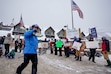 (Francisco Kjolseth | The Salt Lake Tribune) Skiers walk past Park City Mountain ski patrollers on strike on Friday, Dec. 27, 2024.