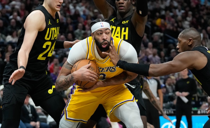 (Francisco Kjolseth  |  The Salt Lake Tribune) Los Angeles Lakers forward Anthony Davis (3) is heavily defended by the Jazz during an NBA basketball game Wednesday, Feb. 14, 2024, in Salt Lake City.