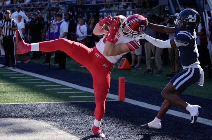 (Francisco Kjolseth  | The Salt Lake Tribune) Utah Utes tight end Caleb Lohner (84) scores a touchdown as Utah State Aggies cornerback JD Drew (3) defends as Utah State hosts the University of Utah during the first half of an NCAA college football game Saturday, Sept. 14, 2024, in Logan, Utah.