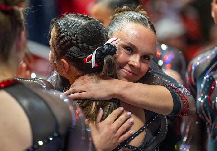 (Rick Egan | The Salt Lake Tribune)  Maile O'Keefe gets hug form a team mate after scoring a 10 on the beam, in gymnastics action between Utah  Red Rocks and Oregon State, at the Jon M. Huntsman Center, on Friday, Feb. 2, 2024.
