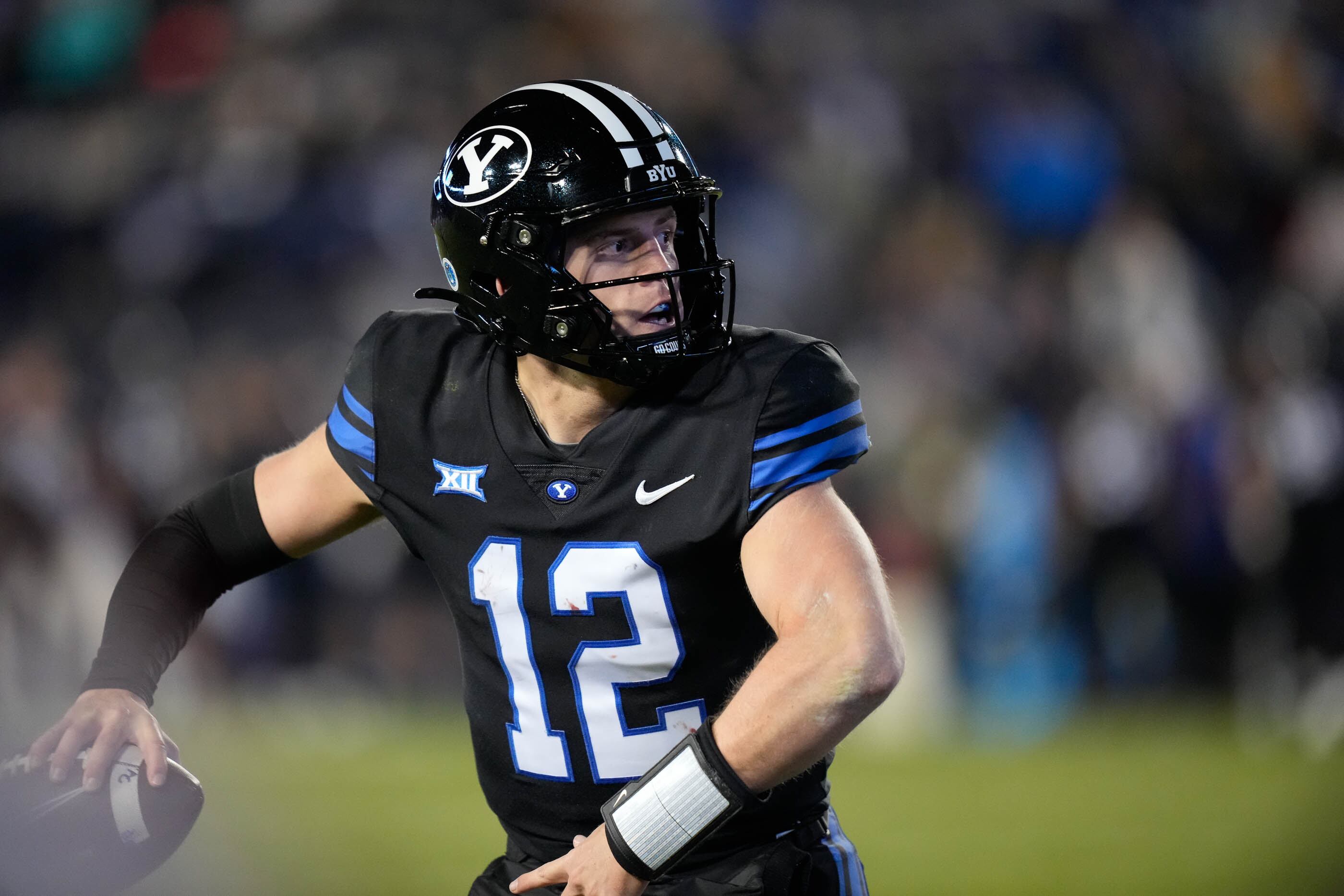 (Francisco Kjolseth | The Salt Lake Tribune) Brigham Young Cougars quarterback Jake Retzlaff (12) runs the ball as he looks for an opening during their NCAA college football loss to Iowa State 45-13 on Saturday, Nov. 11, 2023, in Provo, Utah. 