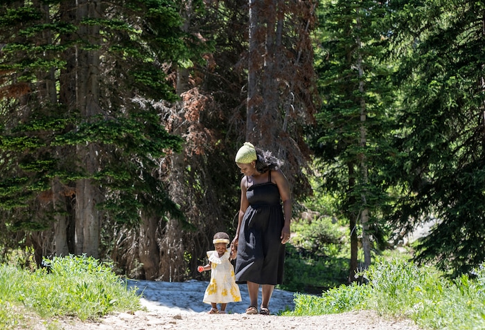 (Rick Egan | The Salt Lake Tribune)  Naomi and Cheryl Neufville look for wildflowers on the trail to Cecret Lake, in Little Cottonwood Canyon, on Wednesday, July 12, 2023.
