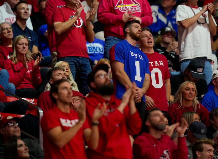 (Bethany Baker  |  The Salt Lake Tribune) Two fans talk together during the game between the Utah Utes and the Brigham Young Cougars at the Jon M. Huntsman Center in Salt Lake City on Saturday, Dec. 9, 2023.