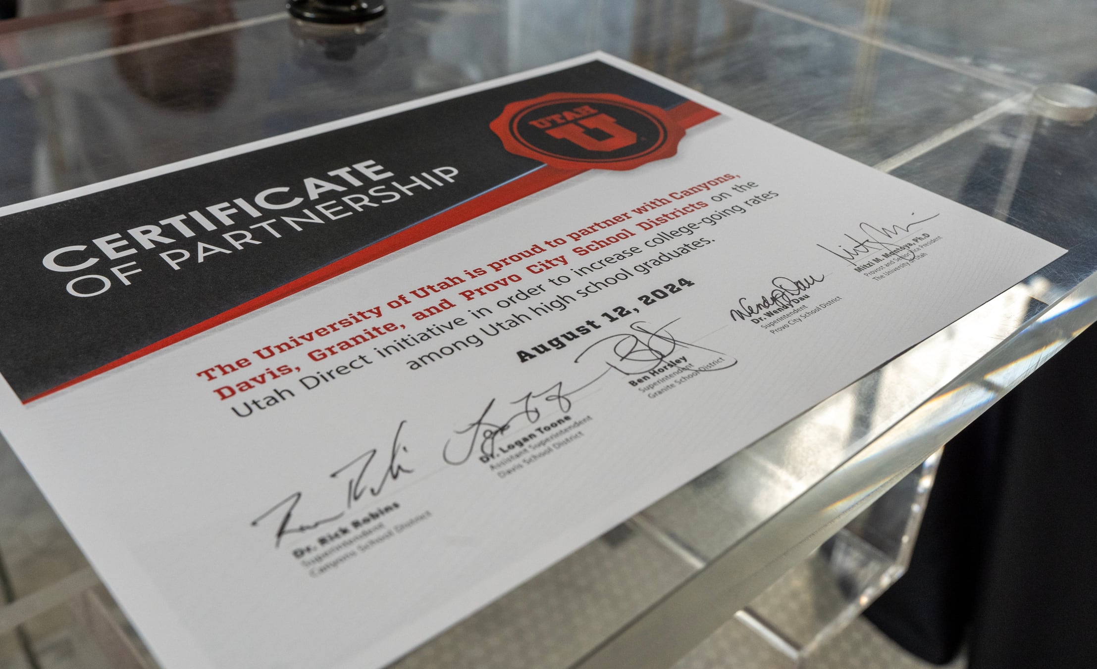 (Chris Samuels | The Salt Lake Tribune) The certificate of partnership at the University of Utah Monday, Aug. 12, 2024, for a new program to offer guaranteed admissions to students in four school districts.