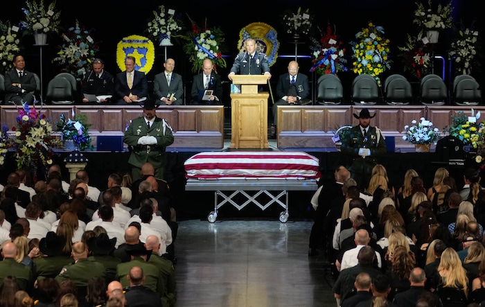 (Francisco Kjolseth  |  The Salt Lake Tribune) Santaquin police Lt. Mike Wall speaks during funeral services for Santaquin police Sgt. Bill Hooser at the UCCU Center at Utah Valley University on Monday, May 13, 2024.