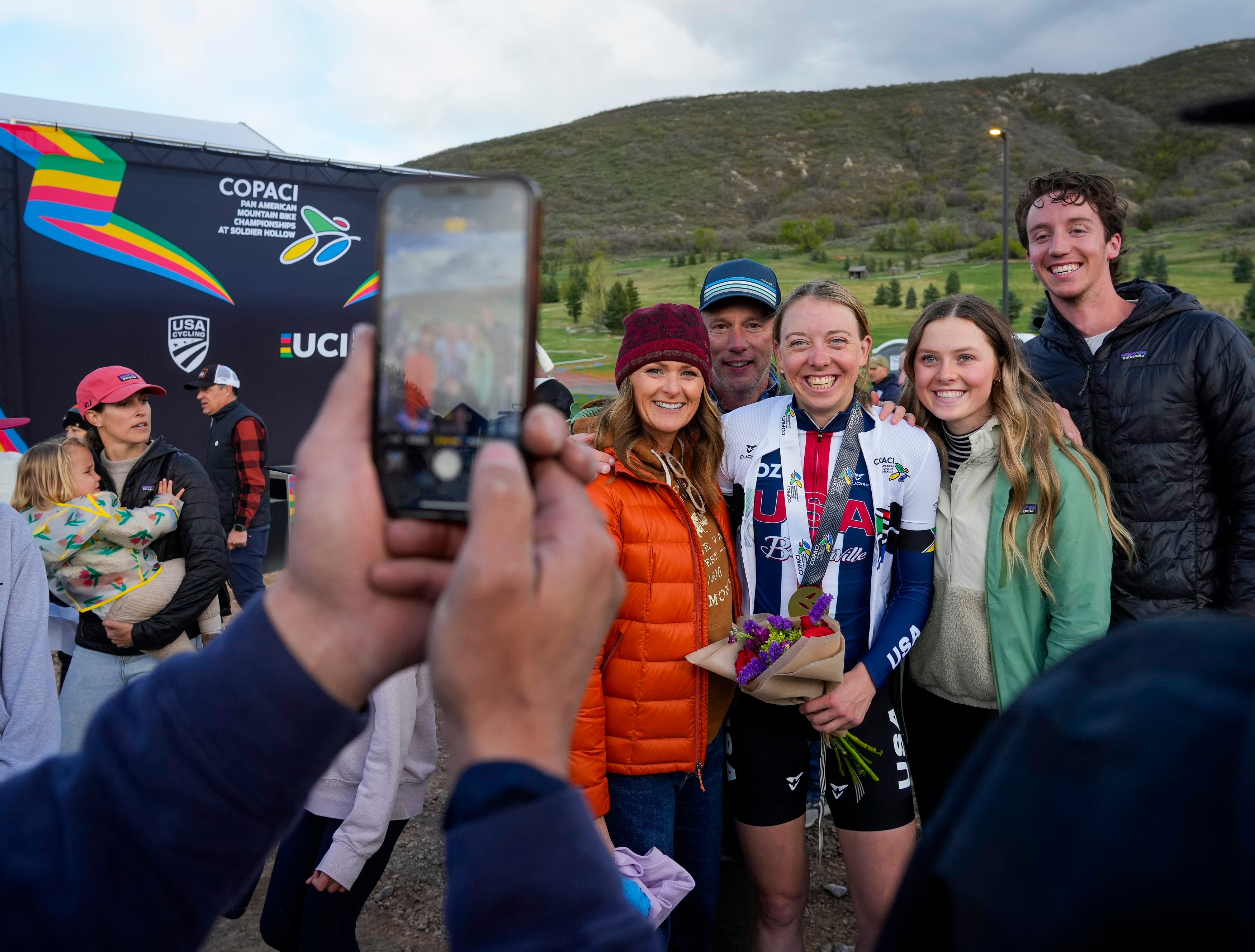 (Bethany Baker | The Salt Lake Tribune) Haley Batten takes a photo with fans following her victory in the Elite Women Short Track race during the Pan American Mountain Biking Championships at Soldier Hollow Nordic Center in Midway on Friday, May 10, 2024.