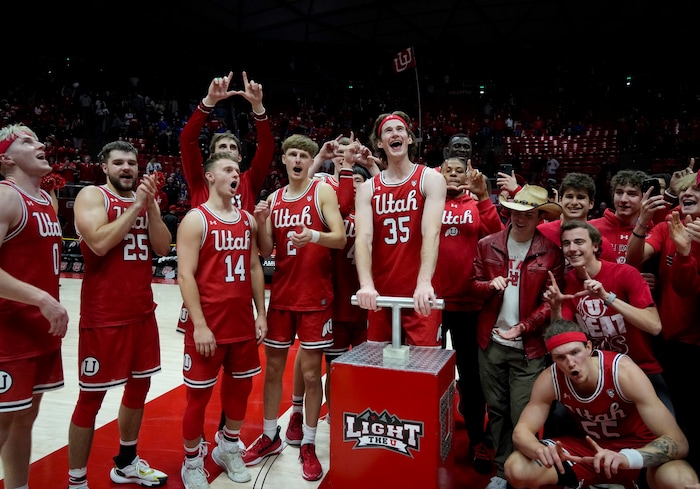 (Bethany Baker  |  The Salt Lake Tribune) The Utah Utes celebrate after defeating the Brigham Young Cougars at the Jon M. Huntsman Center in Salt Lake City on Saturday, Dec. 9, 2023.