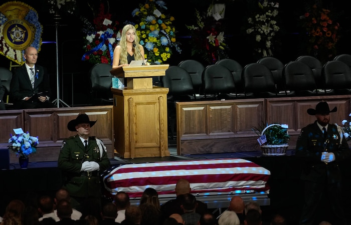 (Francisco Kjolseth  |  The Salt Lake Tribune) Courtney Hooser speaks about her father during funeral services for Santaquin police Sgt. Bill Hooser at the UCCU Center at Utah Valley University on Monday, May 13, 2024.